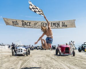 Vintage cars start driving on the beach at the start of The Race of Gentlemen.