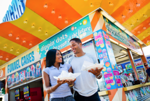A couple on the boardwalk in the Wildwoods enjoying snacks